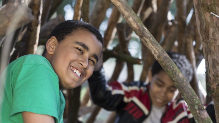 Children playing in the den building area